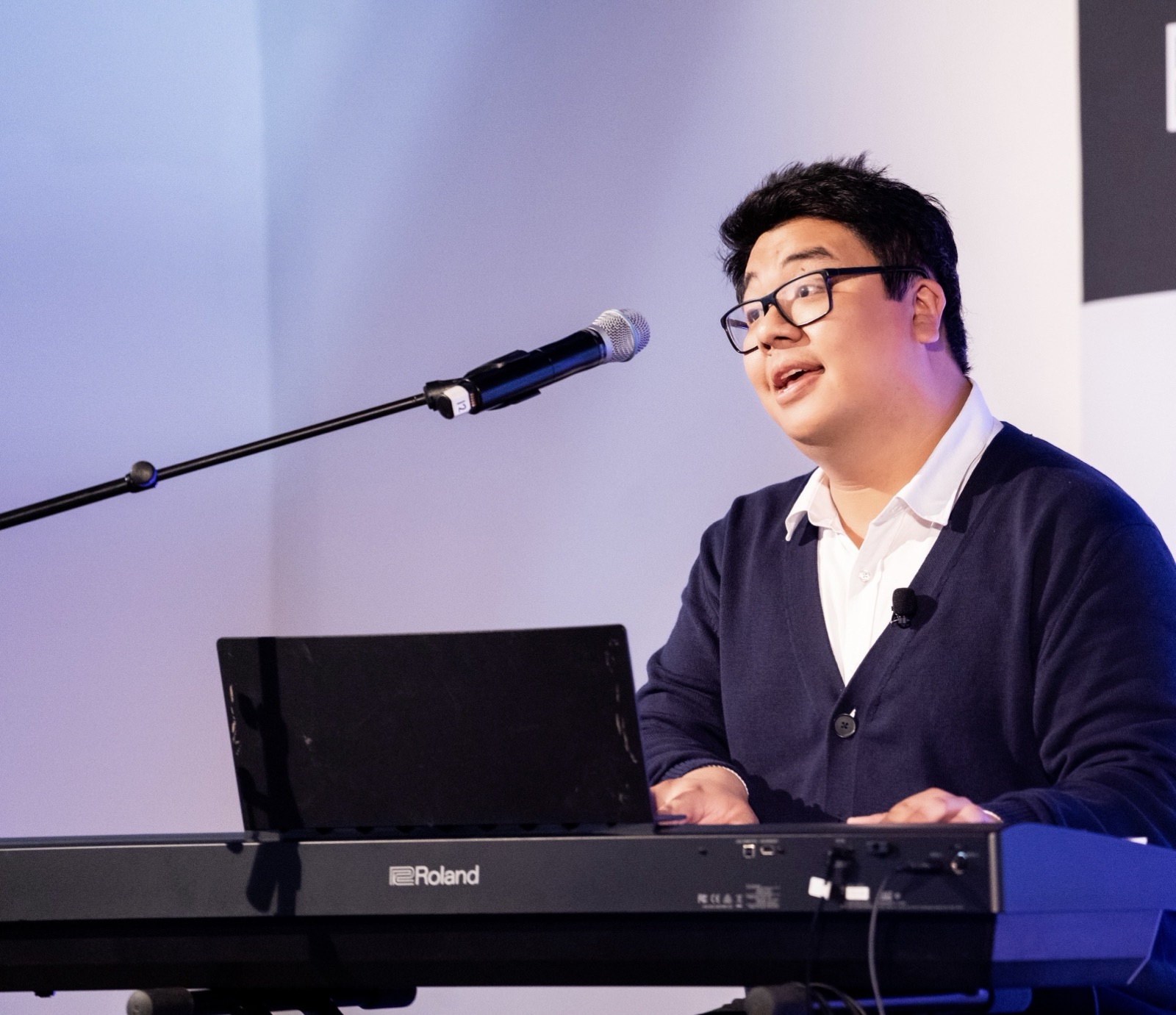 Tiankai Feng singing while playing a Roland keyboard