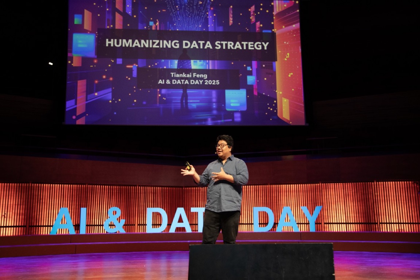 Tiankai Feng presenting Humanizing Data Strategy on stage at AI & Data Day